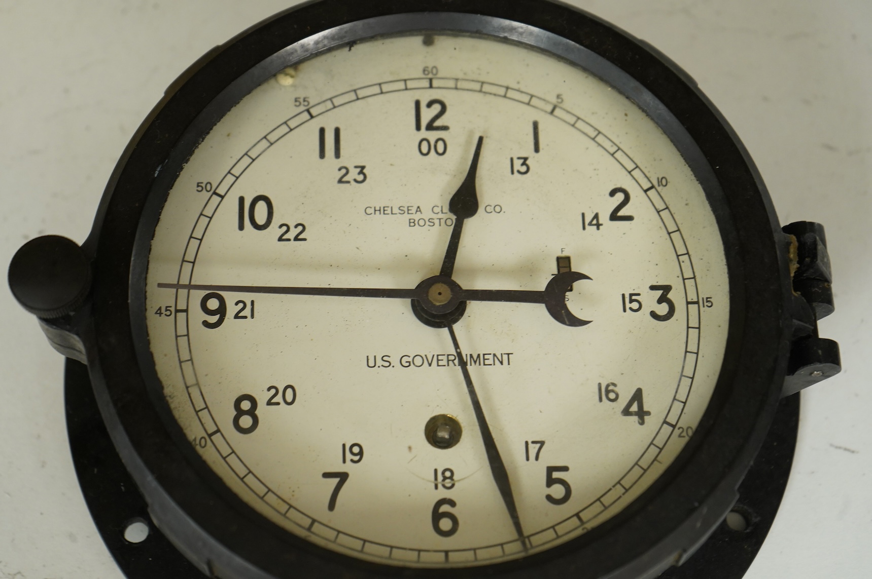A U.S. Government Chelsea Clock Co., Boston, ship’s bulkhead clock in Bakelite case, diameter 17cm with key